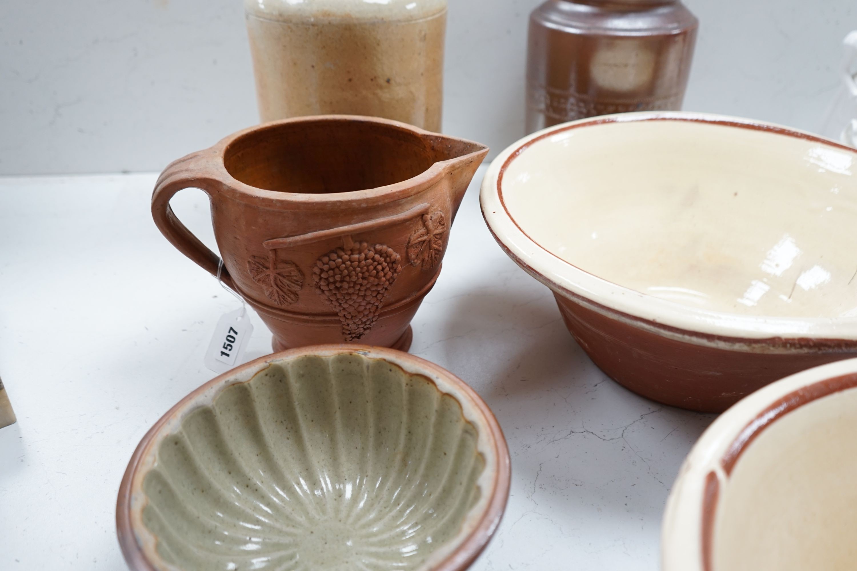 Two Victorian stoneware jars, tallest 33cm, together with two Victorian dairy bowls, a stoneware trivet, a jelly mould and a terracotta jug (7)